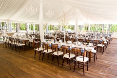 Farm tables under pole tent with liner